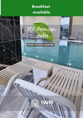 a white bench next to a swimming pool at ICC Ipoh Town Premium Suites By IWH Suites in Ipoh