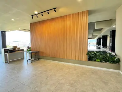 an office lobby with a large wooden wall with plants at ICC Ipoh Town Premium Suites By IWH Suites in Ipoh
