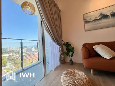 a living room with a couch and a large window at ICC Ipoh Town Premium Suites By IWH Suites in Ipoh