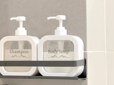 two white baby soap dispensers sitting on a shelf at Anderson Ipoh Blissful Homestay in Ipoh