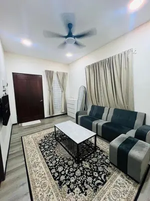 a living room with a couch and a table at Inap Kasih Homestay GM in Gua Musang