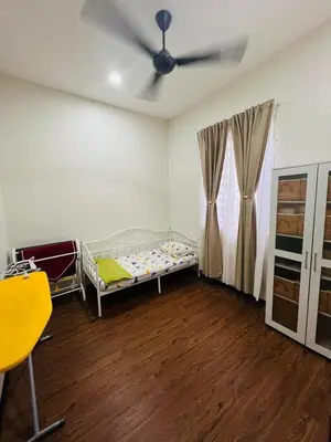 a bedroom with a bed and a ceiling fan at Inap Kasih Homestay GM in Gua Musang