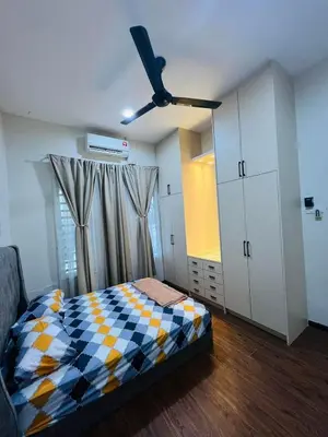 a bedroom with a bed and a ceiling fan at Inap Kasih Homestay GM in Gua Musang