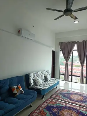 a living room with a blue couch and a ceiling fan at SS APARTMENT MUTIARa in Gua Musang