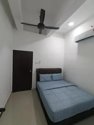 a bedroom with a bed and a ceiling fan at SS APARTMENT MUTIARa in Gua Musang