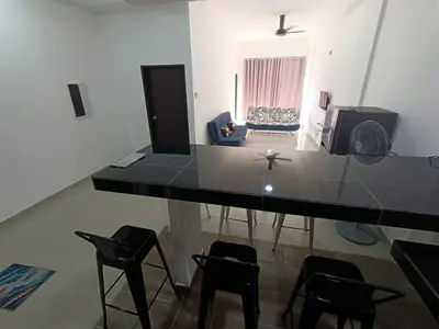 a kitchen with a table and chairs in a room at SS APARTMENT MUTIARa in Gua Musang