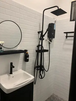 a bathroom with a sink and a camera on the wall at RumaTisa in Teluk Intan