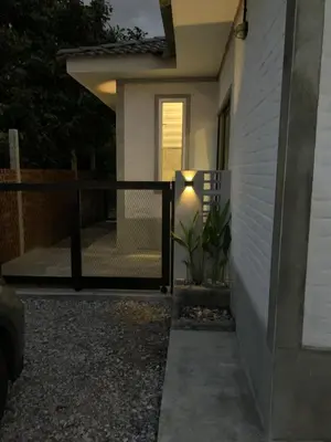 a porch of a home at night with a railing at RumaTisa in Teluk Intan