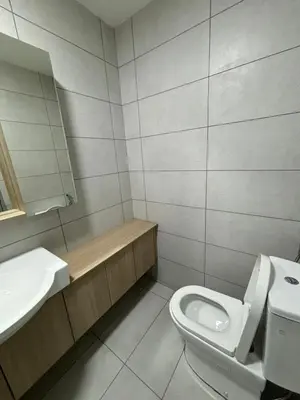 a bathroom with a toilet and a sink at Cozy House in Batu Kawan