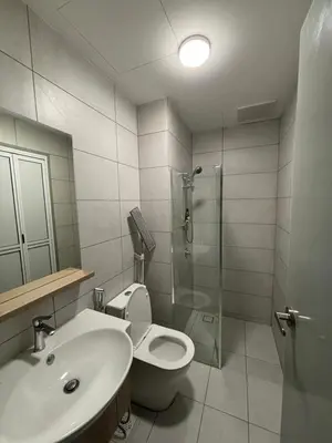 a bathroom with a toilet and a sink and a shower at Cozy House in Batu Kawan