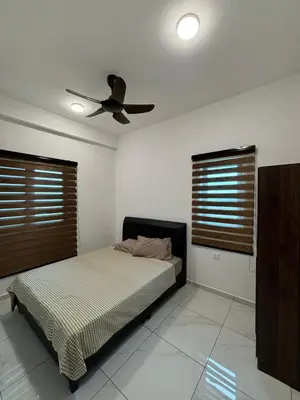 a bedroom with a bed and a ceiling fan at Cozy House in Batu Kawan