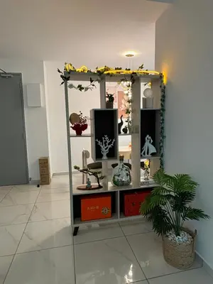 a display case in a room with a plant at Cozy House in Batu Kawan