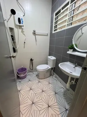 a bathroom with a toilet and a sink at yasmins homestay in Sitiawan