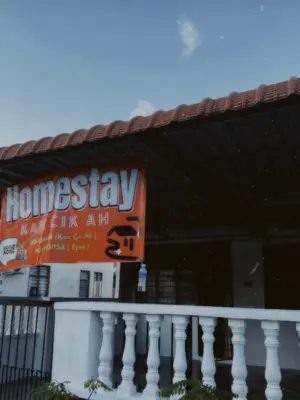 a sign for a house with a sign for a home stay at Homestay KakCik Ah in Kepala Batas
