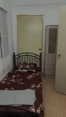 a bedroom with a bed and a door to a doorway at Homestay KakCik Ah in Kepala Batas