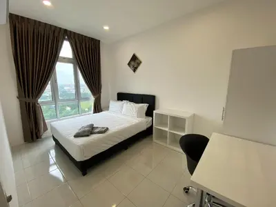 a bedroom with a bed and a large window at EG Home at The Anderson in Ipoh