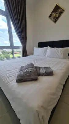 a bed with two pillows on it with a window at EG Home at The Anderson in Ipoh