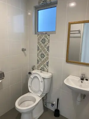 a bathroom with a toilet and a sink at EG Home at The Anderson in Ipoh