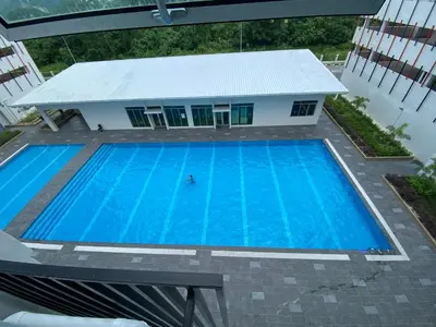 an overhead view of a swimming pool with a building in the background at EG Home at The Anderson in Ipoh