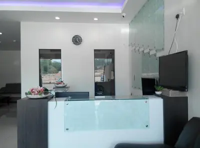 a lobby with a reception desk and a tv at Welcome Inn GM in Gua Musang