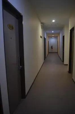 an empty hallway in a building with a door at Welcome Inn GM in Gua Musang