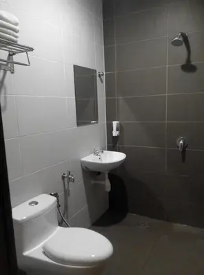 a bathroom with a toilet and a sink at Welcome Inn GM in Gua Musang