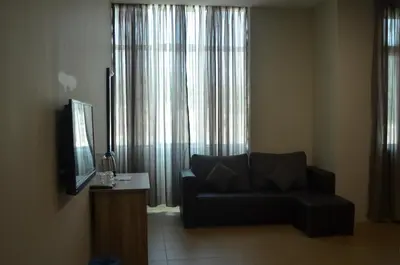 a living room with a couch and a television at Welcome Inn GM in Gua Musang