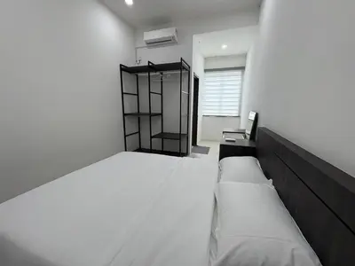 a bedroom with a large bed and a window at \u4e07\u91cc\u671b Menglembu Bestari Homestay in Menglembu