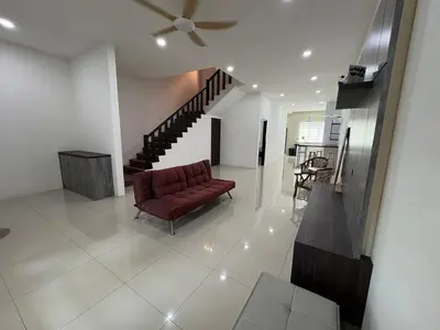 a living room with a red couch and a staircase at \u4e07\u91cc\u671b Menglembu Bestari Homestay in Menglembu