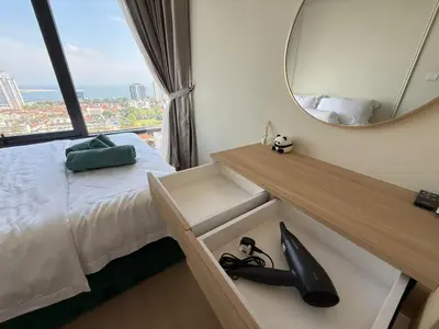 a bedroom with a bed and a mirror and shoes at Macalister Suite - 2 Bedrooms in George Town