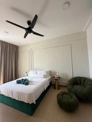 a bedroom with a bed with a ceiling fan at Macalister Suite - 2 Bedrooms in George Town