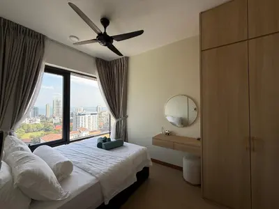 a bedroom with a ceiling fan and a large window at Macalister Suite - 2 Bedrooms in George Town