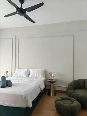 a bedroom with a bed and a ceiling fan at Macalister Suite - 2 Bedrooms in George Town