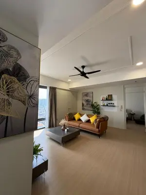 a living room with a couch and a ceiling fan at Macalister Suite - 2 bedrooms in Kampong Makam