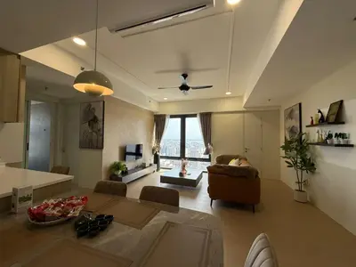 a living room with a couch and a table at Macalister Suite - 2 bedrooms in Kampong Makam