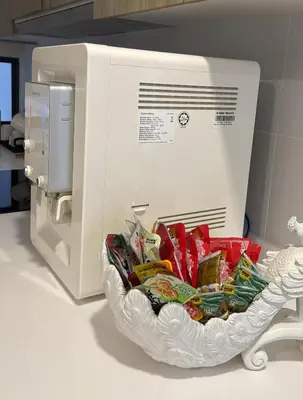 a bowl of food in front of a microwave at Macalister Suite - 2 bedrooms in Kampong Makam