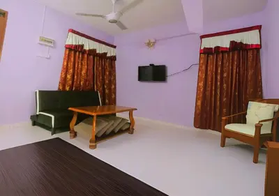 a living room with a couch and a table and chairs at COZY Home Terrace - 1km to Water Theme Park Tambun Ipoh in Ipoh