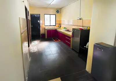 a kitchen with red cabinets and a black refrigerator at COZY Home Terrace - 1km to Water Theme Park Tambun Ipoh in Ipoh