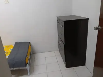 a small room with a bed and a cabinet at Homestay Jannati Bandar Baru Putra Ipoh in Ipoh