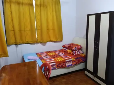a small room with a table and a bed at Homestay Jannati Bandar Baru Putra Ipoh in Ipoh