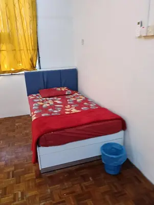 a small bedroom with a bed with a red blanket at Homestay Jannati Bandar Baru Putra Ipoh in Ipoh
