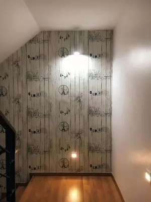 a room with a wooden wall with a light on it at Shamrock Boutique Villa - Stay for 12 person in Batu Ferringhi