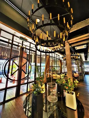 a large chandelier in a restaurant with a table at M Boutique Hotel Station 18 - Ipoh in Ipoh