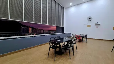 a dining area with tables and chairs in a room at Kampar Lake House - Bandar Baru Kampar City Centre in Kampar