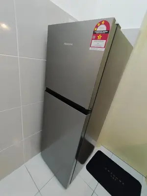 a refrigerator with a sticker on it in a kitchen at Kampar Lake House - Bandar Baru Kampar City Centre in Kampar