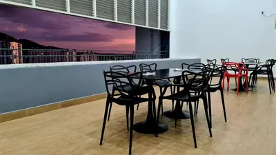 a group of tables and chairs on a balcony at Kampar Lake House - Bandar Baru Kampar City Centre in Kampar