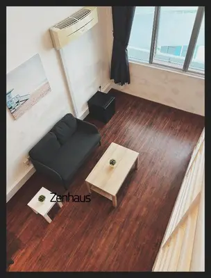 a living room with a black couch and a table at THE CEO LOFT by Zenhaus in Bayan Lepas
