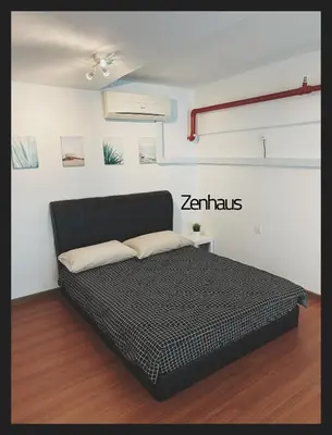 a bedroom with a black bed in a room at THE CEO LOFT by Zenhaus in Bayan Lepas