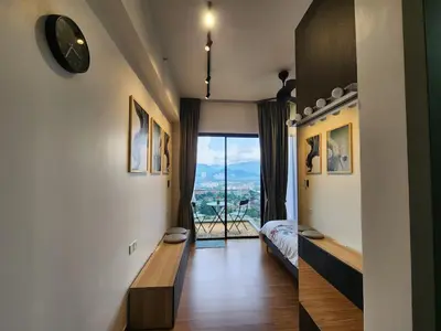 a room with a view of a bedroom with a window at Georgetown Modern CosyStay in George Town