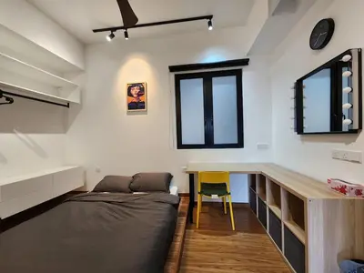 a bedroom with a bed and a desk at Georgetown Modern CosyStay in George Town